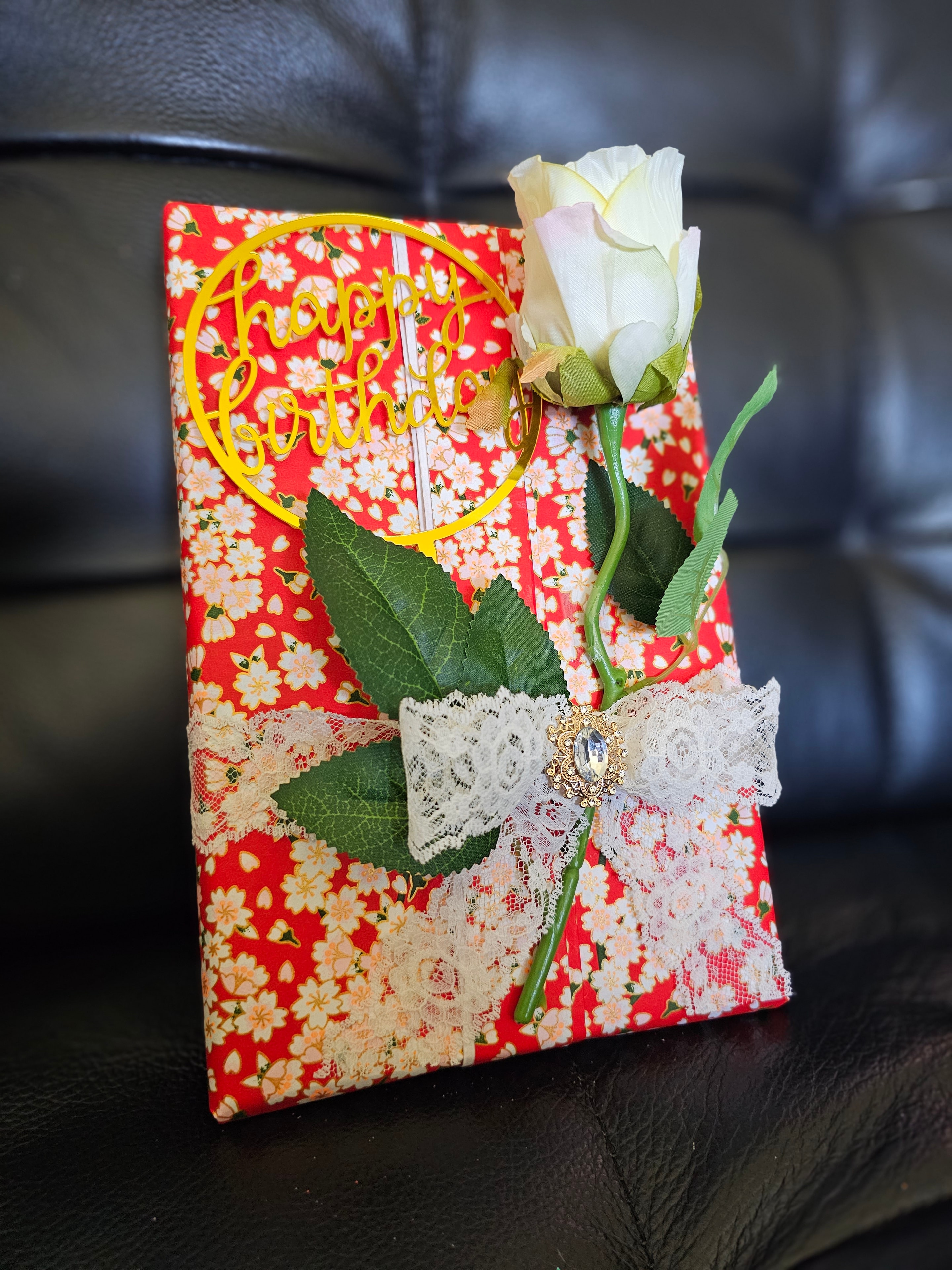 Beautifully wrapped gift with gold ribbon flat lay